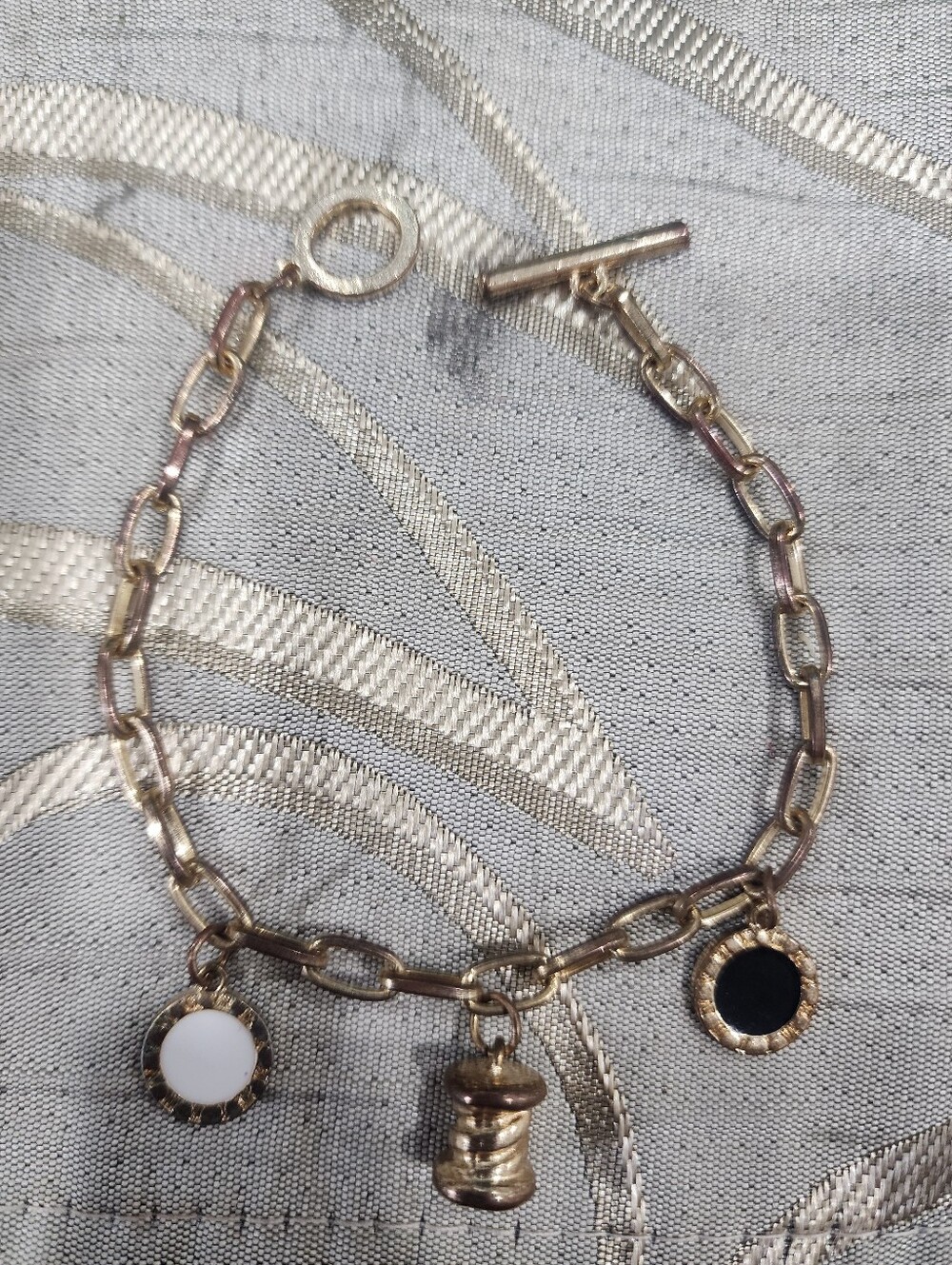 Gold-Tone Charm Bracelet with Black and White Discs